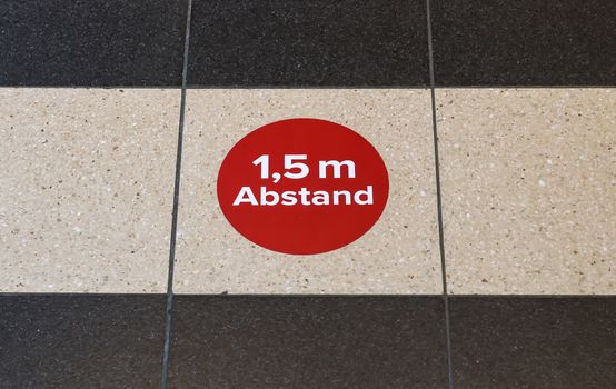 Bitte Abstand Halten! 1.5 meter social distancing sign for COVID-19. Keep distance symbol in german language