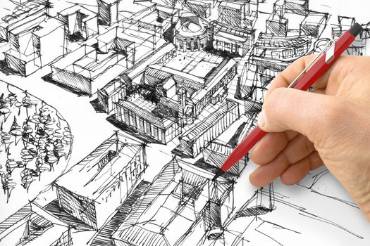 Planning a new city - Engineer-architect drawing with a pencil a sketch of a new modern imaginary town - concept image.