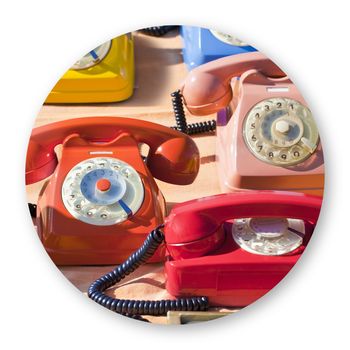 Old colored plastic analog phone in a flea market - Round icon concept image.