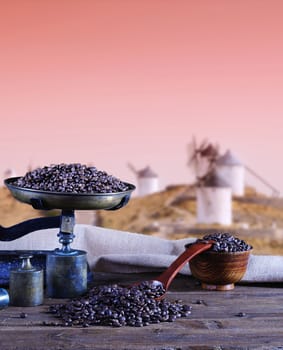 Coffee with scale and old windmill background.