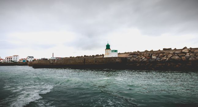 Port Joinville on the island of Yeu - September 18, 2018: entrance to the port of the island of Yeu with its semaphore and typical small houses on a fall day