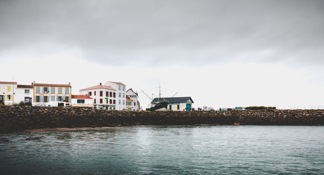 Port Joinville on the island of Yeu - September 18, 2018: entrance to the port of the island of Yeu with its semaphore and typical small houses on a fall day