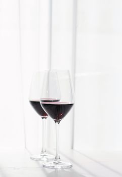 Two crystal glasses of red wine, organic beverage product