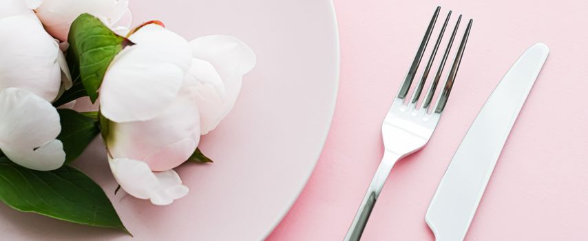 Dining plate and cutlery with peony flowers as wedding decor set on pink background, top tableware for event decoration and menu branding design