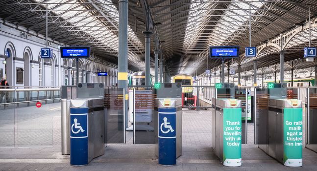 Dublin, Ireland - February 13, 2019: Access turnstile at the platform at Heuston station where trains are parked on a winter day