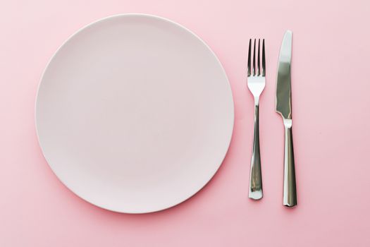 Empty plate and cutlery as mockup set on pink background, top tableware for chef table decor and menu branding design