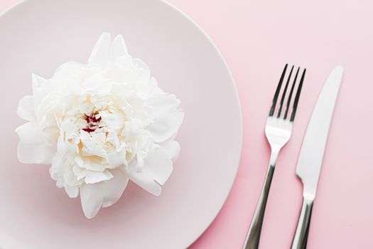 Dining plate and cutlery with peony flower as wedding decor set on pink background, top tableware for event decoration and dessert menu design