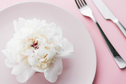 Dining plate and cutlery with peony flower as wedding decor set on pink background, top tableware for event decoration and dessert menu design