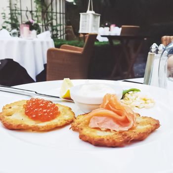 Potato pancakes with salmon and caviar in luxury restaurant, food and cuisine concept