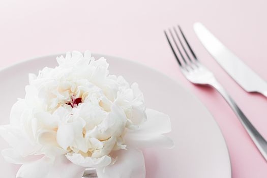 Dining plate and cutlery with peony flower as wedding decor set on pink background, top tableware for event decoration and dessert menu design