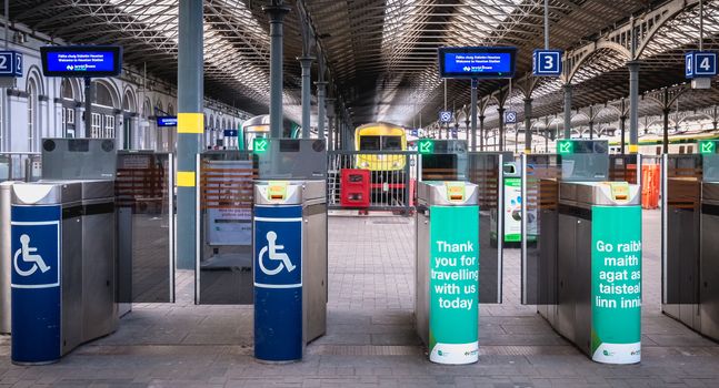 Dublin, Ireland - February 13, 2019: Access turnstile at the platform at Heuston station where trains are parked on a winter day