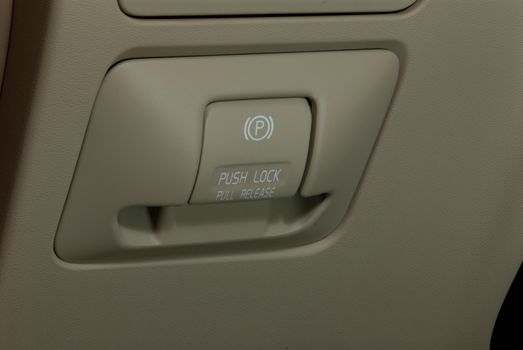 detail in a car with electric parking brake button