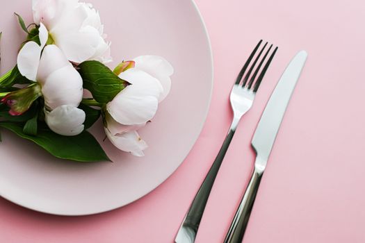 Dining plate and cutlery with peony flowers as wedding decor set on pink background, top tableware for event decoration and menu branding design