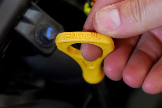 A Person Checking the Motor Oil in Their Car