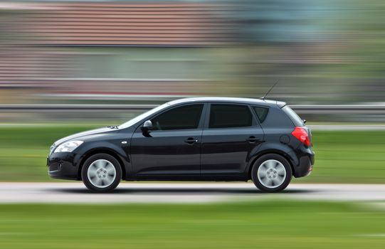 A panning shot of a speeding car