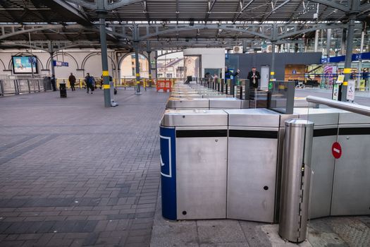 Dublin, Ireland - February 13, 2019: Access turnstile at the platform at Heuston station where trains are parked on a winter day