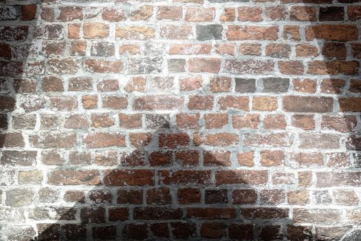 Aged and weathered brick wall textures with bright spotlight illumination