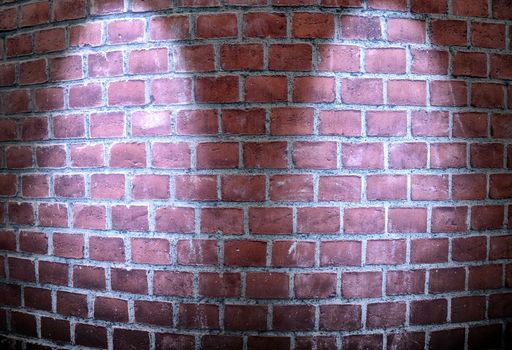 Aged and weathered brick wall textures with bright spotlight illumination