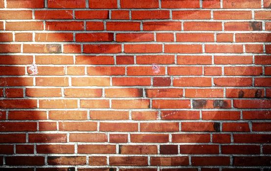 Aged and weathered brick wall textures with bright spotlight illumination