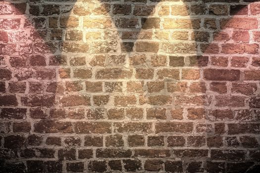 Aged and weathered brick wall textures with bright spotlight illumination