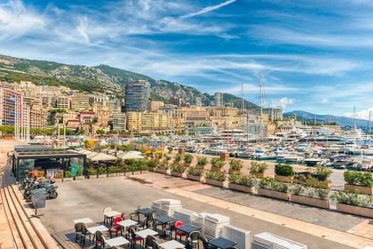 View over luxury yachts and apartments of Port Hercules in La Condamine district, city centre and harbour of Monte Carlo, Cote d'Azur, Principality of Monaco, iconic landmark of the French Riviera