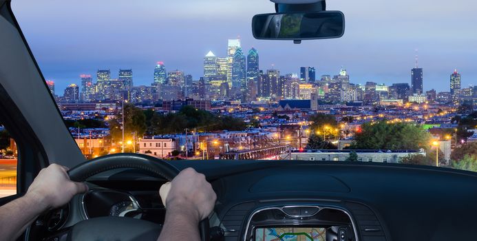 Driving a car towards Philadelphia skyline at night as seen from the Stadium District, USA