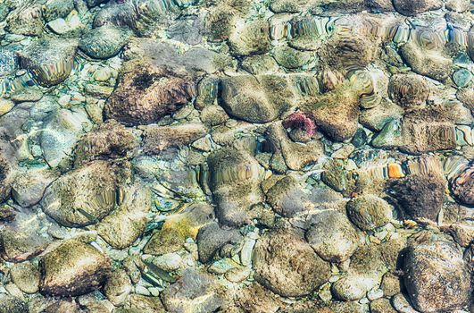 Underwater pebbles at the seaside. May be used as background