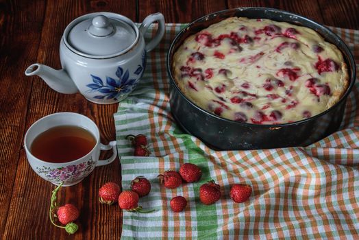 Breakfast with homemade strawberry pie, black tea and berries