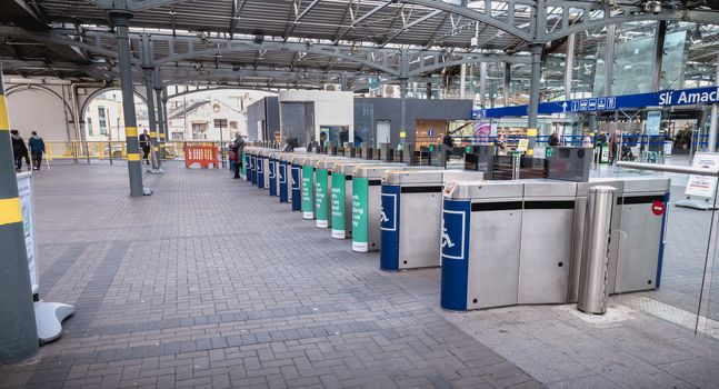 Dublin, Ireland - February 13, 2019: Access turnstile at the platform at Heuston station where trains are parked on a winter day
