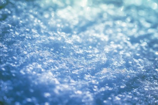 Macro background of fresh snowflake texture on a blur.