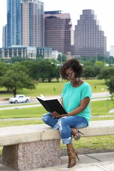 Beautiful African American woman reading a book, Austin, Texas background