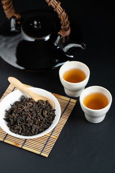 Hot tea in glass teapot and cup with steam