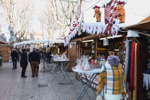 Marseillan, France - December 30, 2018: Street atmosphere in the Christmas market of the city where people walk on a winter day