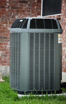 Air conditioner close up in front of brick wall