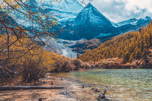 Pearl Lake or Zhuoma La Lake and snow mountain in autumn in Yading Nature reserve, Sichuan, China.