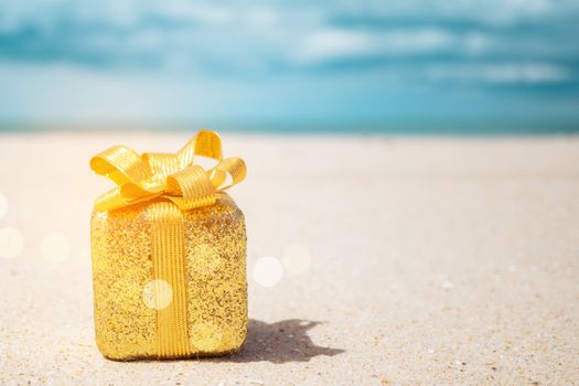 Gift boxes on sandy beach. Hot tours or holiday vacation concept with summer sea background.