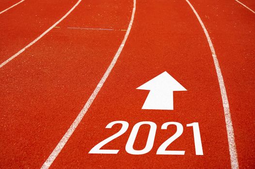 Start line to 2021 on running court represents the beginning of a journey to the destination in business planning, strategy and challenge or career path, opportunity concept.