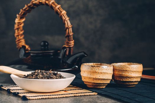 Hot tea in glass teapot and cup with steam