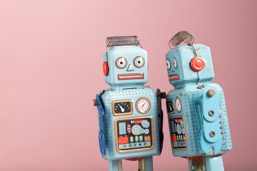 Vintage robot tin toy on pink background
