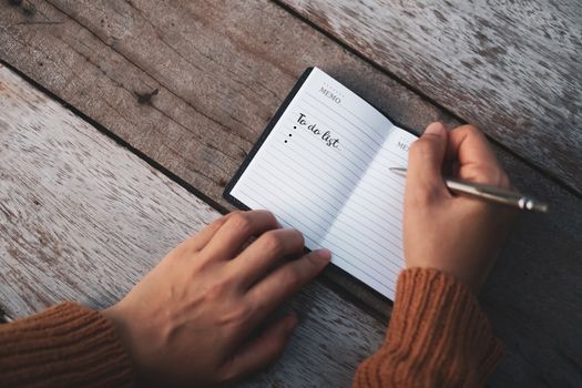 Top view of to do list on notebook paper with pen on table vintage style.