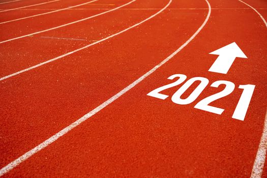 Start line to 2021 on running court represents the beginning of a journey to the destination in business planning, strategy and challenge or career path, opportunity concept.