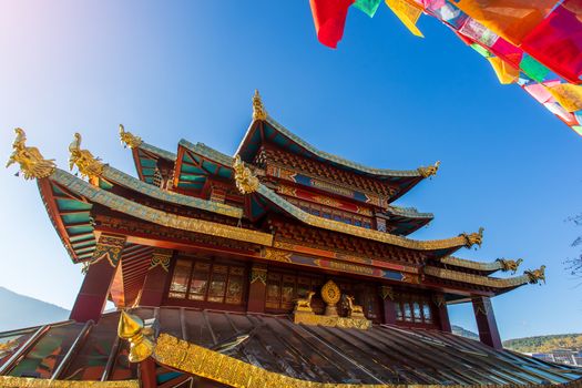 Guishan temple with giant buddhist tibetan prayer golden wheel in old town Shangri la