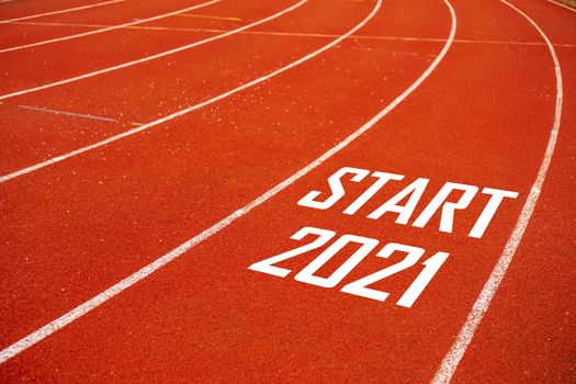 Start line to 2021 on running court represents the beginning of a journey to the destination in business planning, strategy and challenge or career path, opportunity concept.