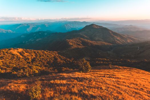 colorful dramatic sky with cloud at sunset  in the mountains