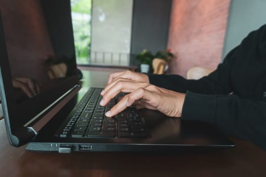 Woman hand using laptop to work study on work desk with clean nature background background. Business, financial, trade stock maket and social network concept.