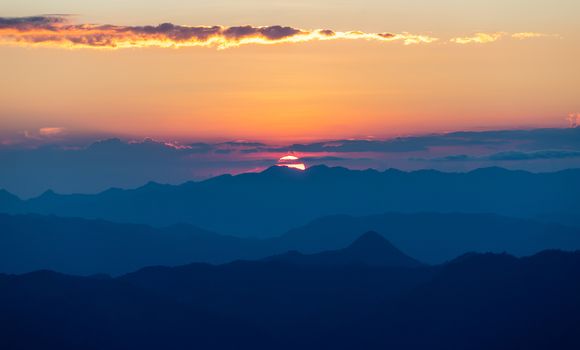 colorful dramatic sky with cloud at sunset  in the mountains