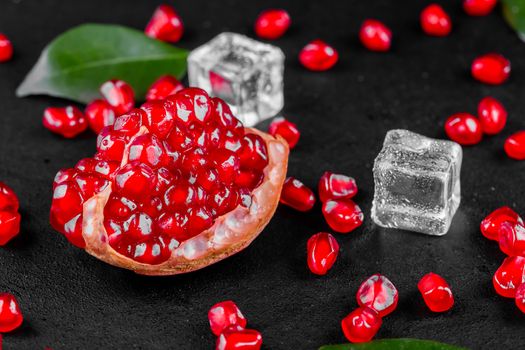 Ripe pomegranate fruits on the wooden background