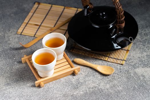 Hot tea in glass teapot and cup with steam