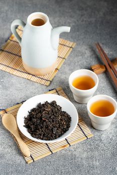 Hot tea in glass teapot and cup with steam