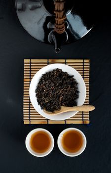 Hot tea in glass teapot and cup with steam